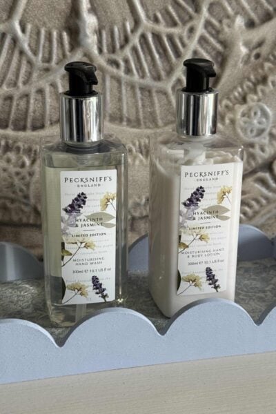 A DIY scalloped tray lined with wallpaper and holding a soap and lotion set.