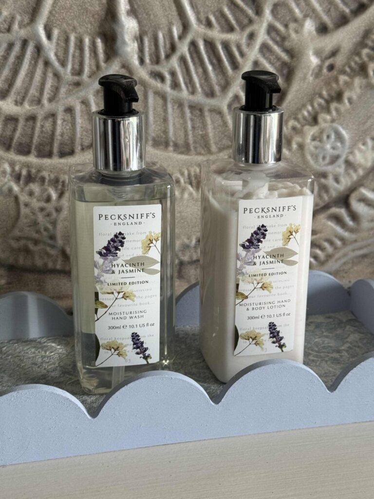 A blue DIY scalloped tray holding matching bottles of hand soap and lotion. 