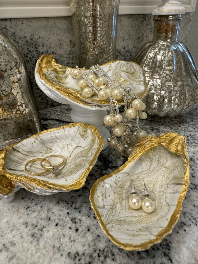 DIY gold and white decoupage trinket dishes made from oyster shells