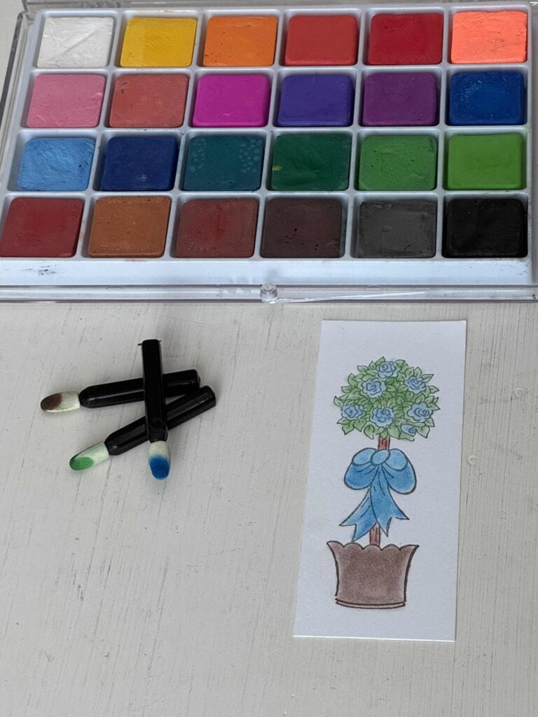 A set of blending chalks with three foam applicators used to color the topiary stamp. 
