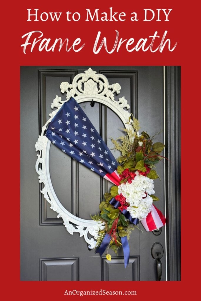 An ornate white oval frame hangs on a black door, decorated with a folded American flag, white and red flowers, greenery, and ribbon—perfect inspiration for your own DIY Frame Wreath. The text above reads, How to Make a DIY Frame Wreath.